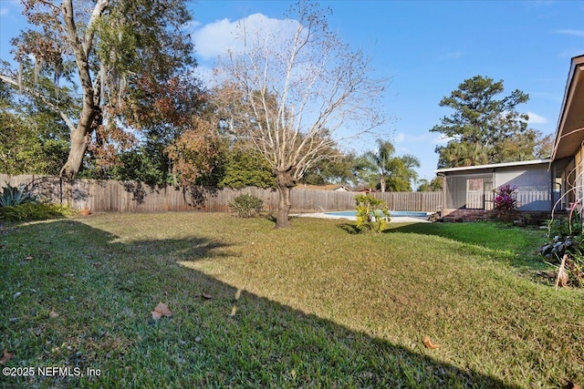 view of yard with a fenced in pool