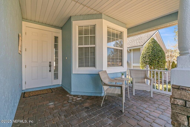 property entrance featuring covered porch