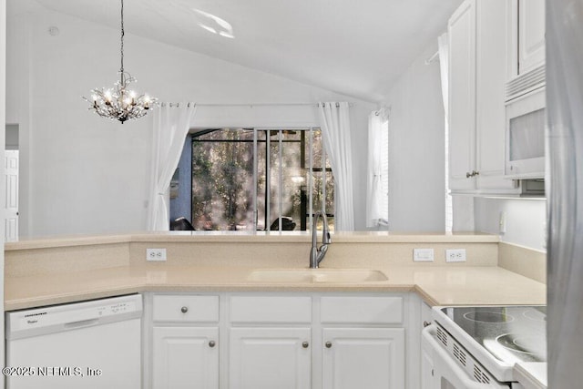 kitchen featuring lofted ceiling, sink, white appliances, and white cabinets