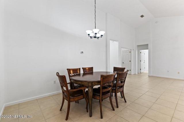 dining space featuring high vaulted ceiling, light tile patterned floors, and a notable chandelier