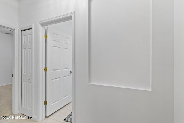 hall featuring light tile patterned floors