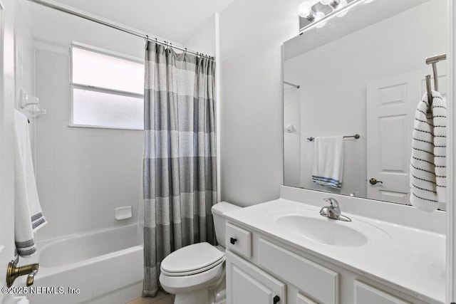 full bathroom featuring vanity, shower / bath combination with curtain, and toilet