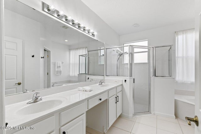 bathroom with tile patterned floors, independent shower and bath, and vanity