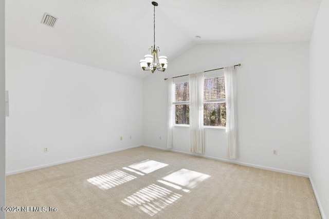 unfurnished room with an inviting chandelier, light colored carpet, and lofted ceiling