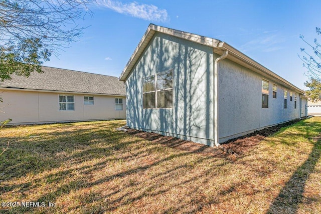 back of house with a lawn