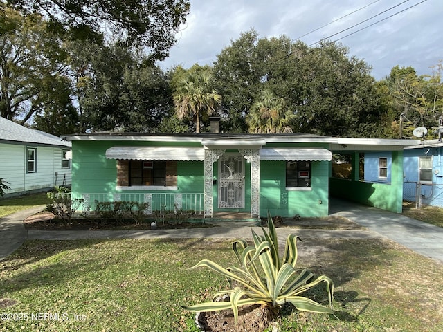 ranch-style house with a carport and a front lawn