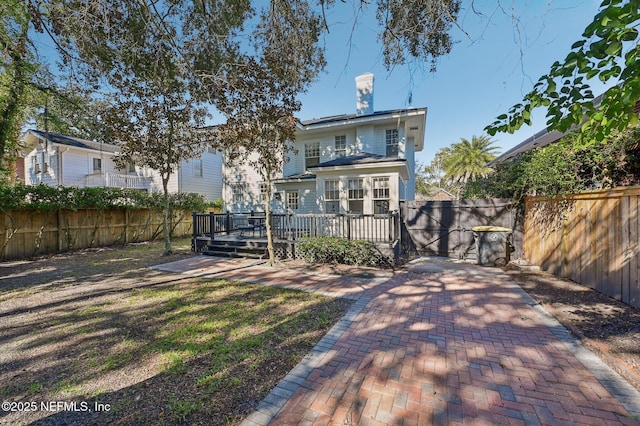 rear view of house with a wooden deck