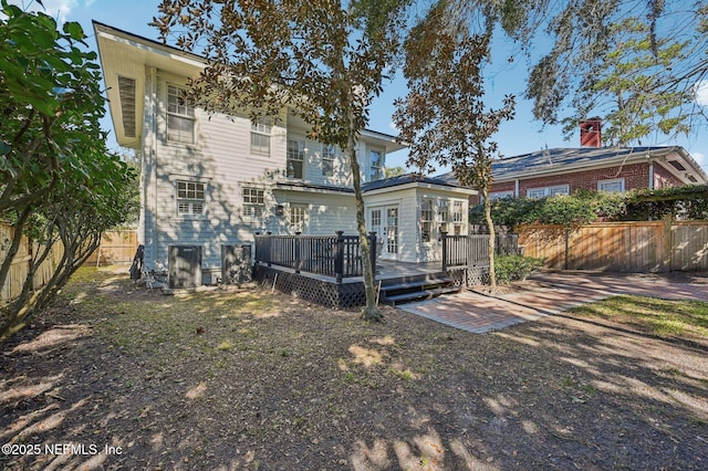 back of property featuring a wooden deck