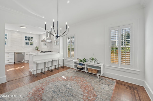 dining space featuring crown molding and dark hardwood / wood-style flooring