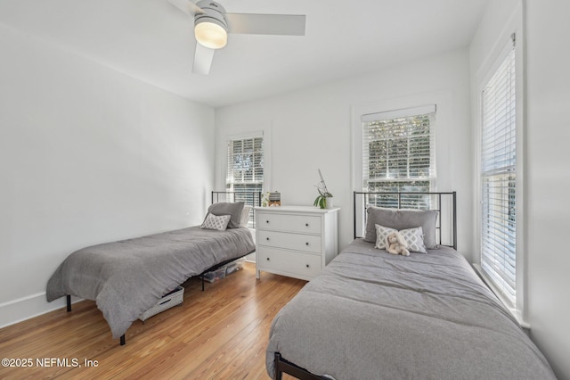 bedroom with ceiling fan and light hardwood / wood-style floors