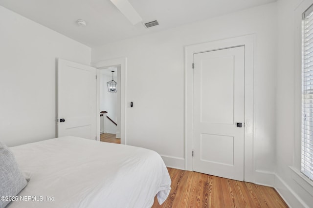 bedroom with hardwood / wood-style flooring