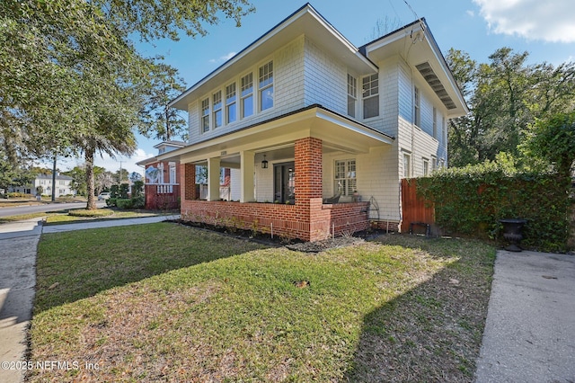 view of front of house featuring a front yard and a porch