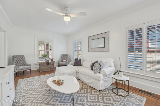 living room with ceiling fan, ornamental molding, and dark hardwood / wood-style floors