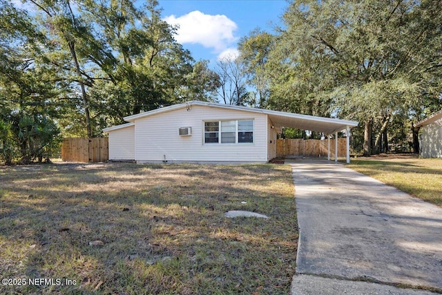 view of front of house with a front yard and a carport