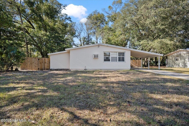 exterior space with a lawn and a carport