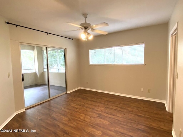 unfurnished bedroom featuring dark hardwood / wood-style floors, ceiling fan, and a closet