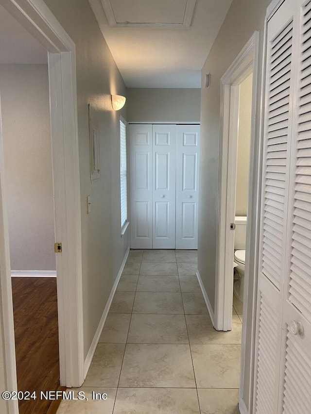 hall featuring light tile patterned floors