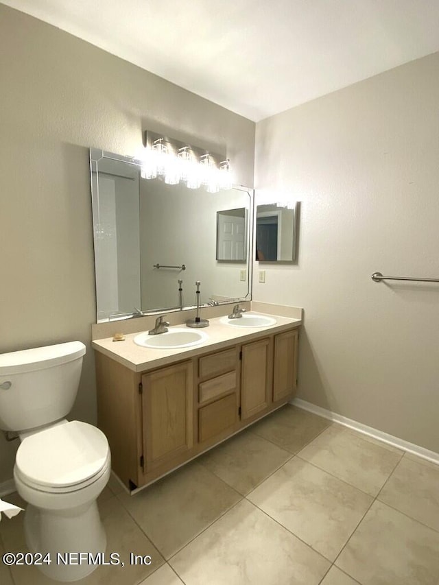 bathroom with vanity, tile patterned floors, and toilet