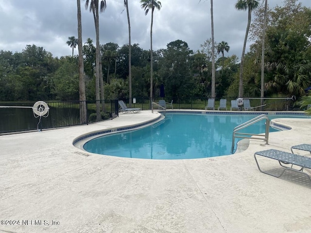 view of swimming pool featuring a patio area