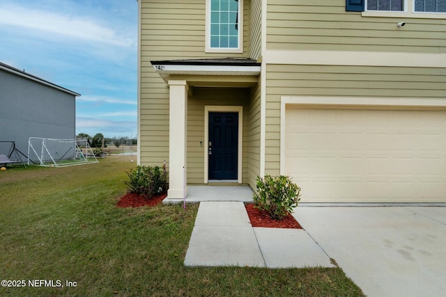 entrance to property featuring a garage and a yard