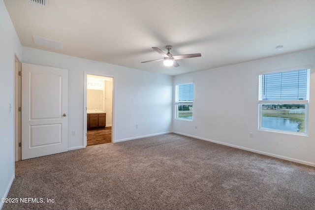 unfurnished bedroom featuring carpet flooring, connected bathroom, and ceiling fan