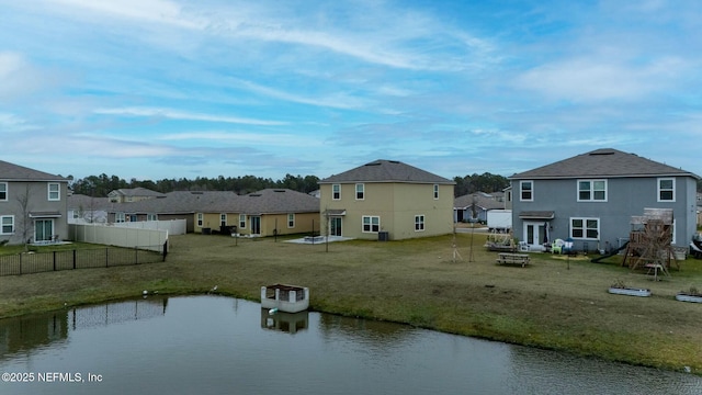 rear view of property featuring a yard and a water view