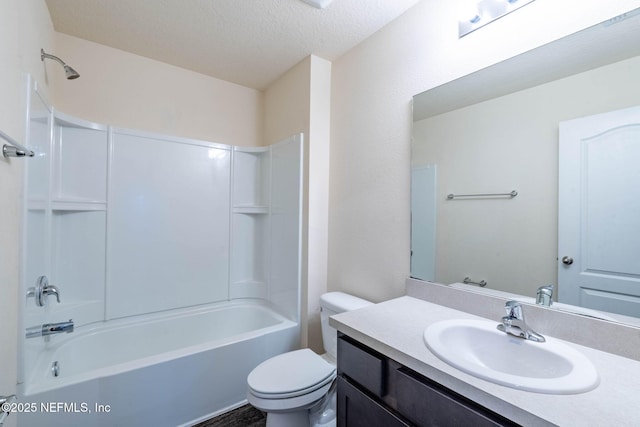 full bathroom featuring vanity, toilet, bathing tub / shower combination, and a textured ceiling