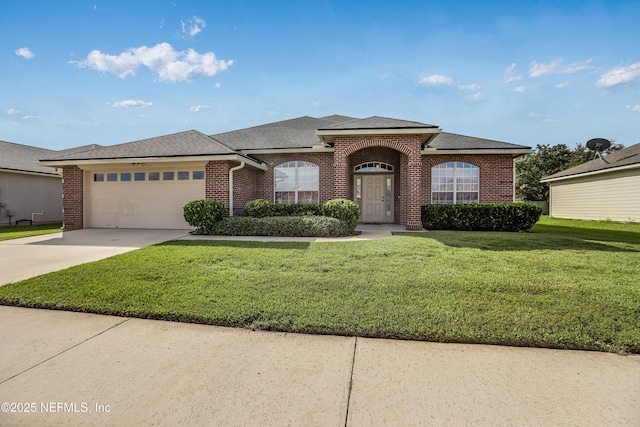 view of front of house featuring a garage and a front lawn