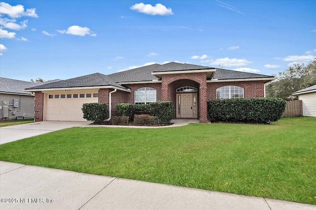 view of front of property featuring a garage and a front lawn