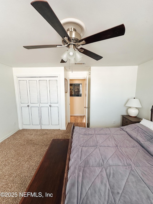 unfurnished bedroom with a closet, ceiling fan, and carpet floors