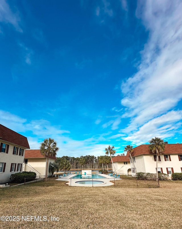 view of pool featuring a lawn