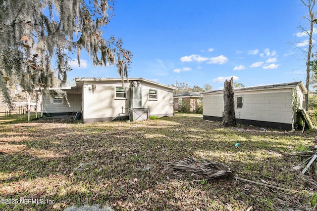 rear view of property with a lawn