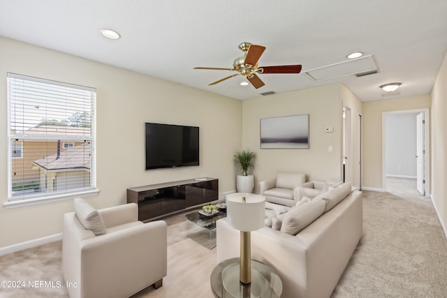 carpeted living room featuring ceiling fan