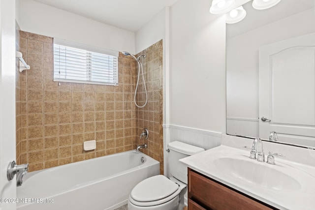 full bathroom featuring tiled shower / bath combo, toilet, wooden walls, and vanity