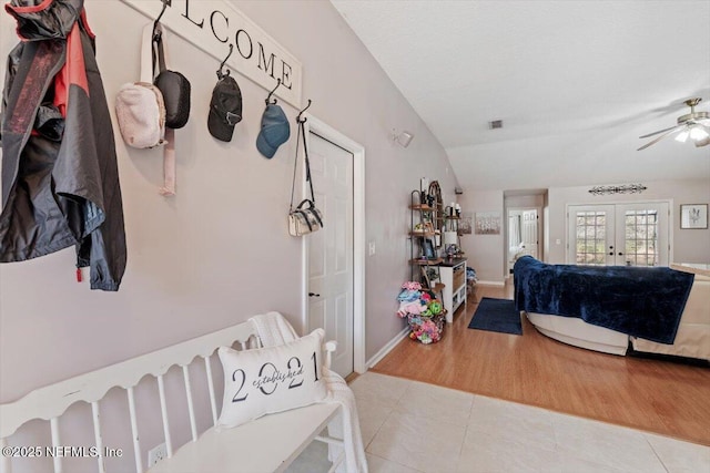 mudroom featuring ceiling fan, light tile patterned floors, lofted ceiling, and french doors