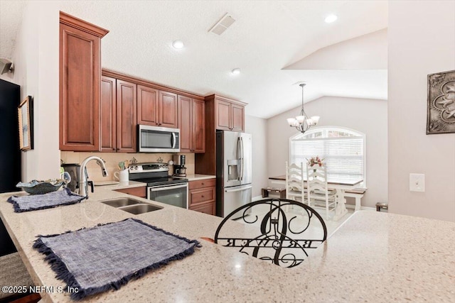 kitchen featuring kitchen peninsula, vaulted ceiling, sink, a chandelier, and stainless steel appliances