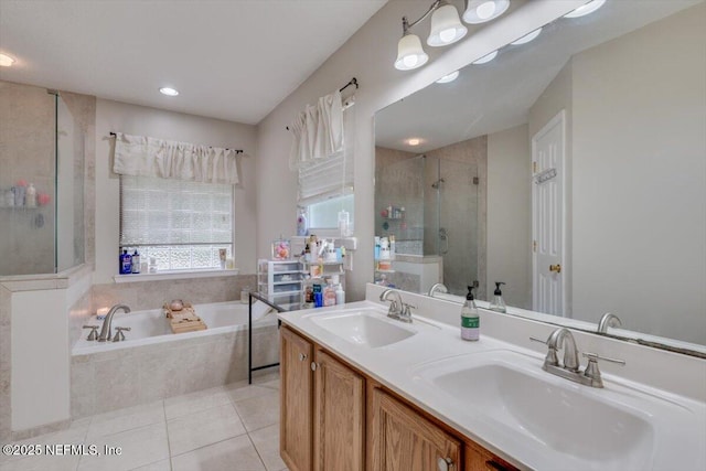 bathroom with tile patterned floors, vanity, and separate shower and tub