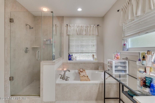 bathroom featuring separate shower and tub