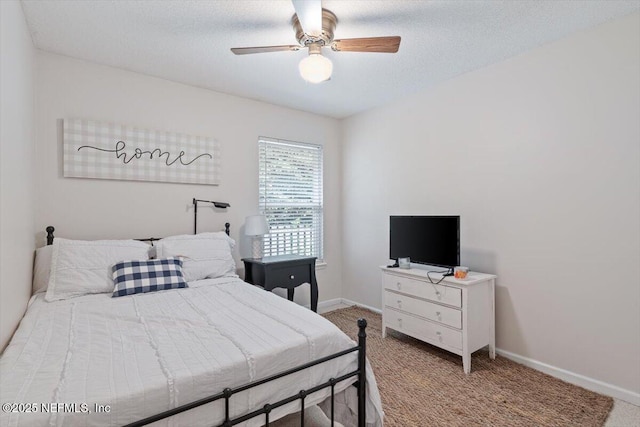 bedroom featuring ceiling fan, a textured ceiling, and light carpet