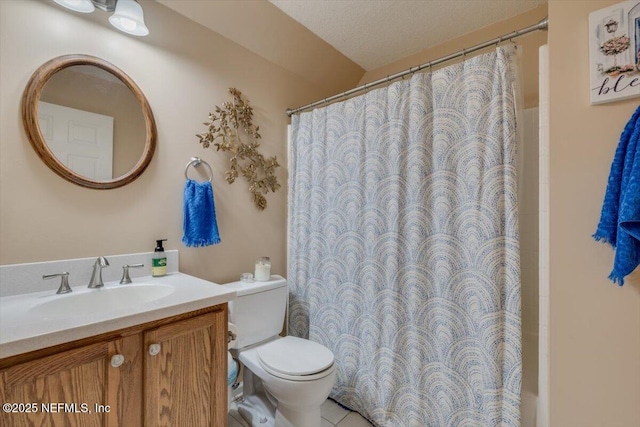 bathroom featuring a textured ceiling, toilet, and vanity