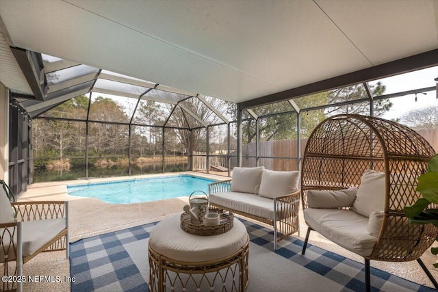 view of pool with glass enclosure, an outdoor hangout area, and a patio area