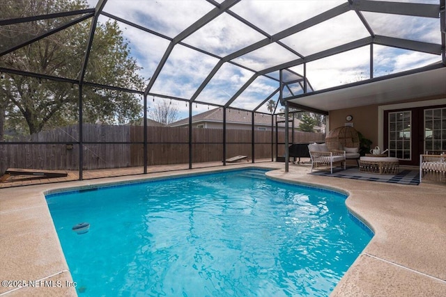 view of swimming pool with glass enclosure, an outdoor living space, and a patio