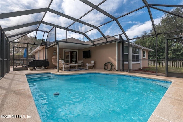 view of pool with a patio area and a lanai