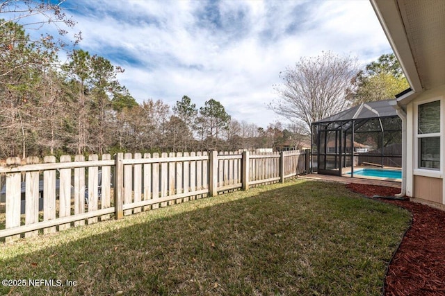 view of yard with a fenced in pool and a lanai