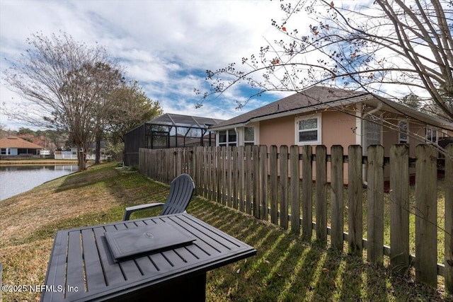 exterior space with a lanai and a water view