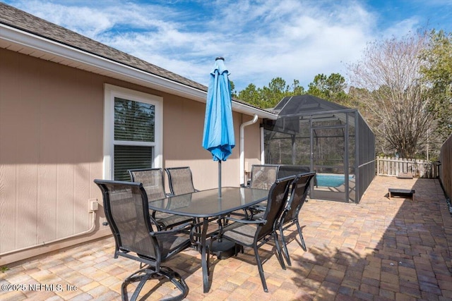 view of patio / terrace with a pool and glass enclosure