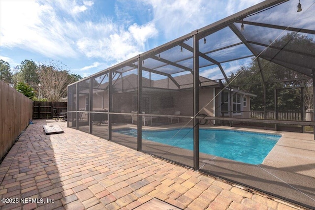 view of pool with a patio and a lanai