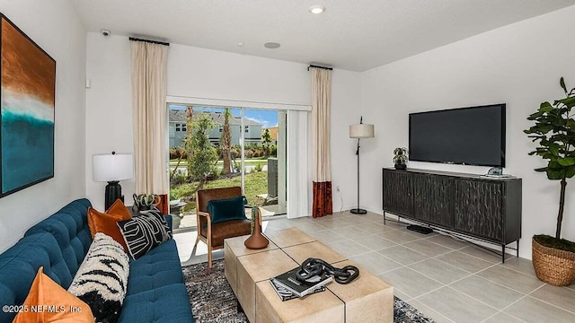 living room with a textured ceiling and light tile patterned flooring