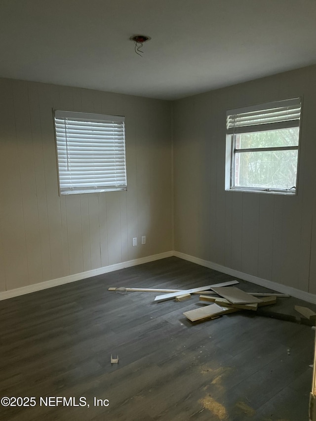 empty room with dark hardwood / wood-style floors