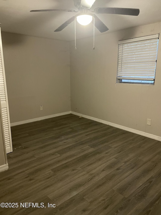 empty room with ceiling fan and dark hardwood / wood-style floors